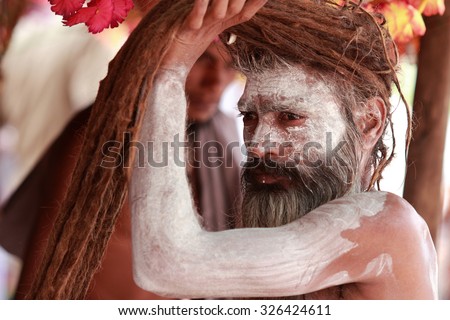 NASHIK - SEP 12:An unidentified Naga Sadhu gets ready to participate in the religious event Kumbh Mela on September 12, 2015 in Nashik, India.Kumbhmela is a Hindu religious event gathered by millions.