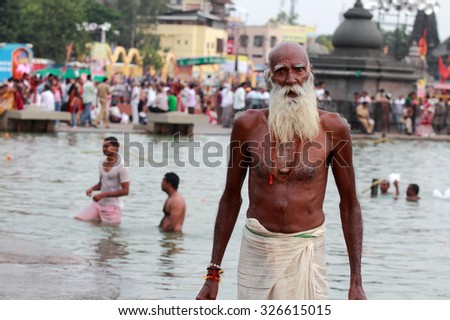 NASHIK - SEP 14:Unidentified devotees take bath in the river Godavari during the event Kumbh Mela on September 14, 2015 in Nashik, India.Kumbhmela is a Hindu religious event gathered by millions.
