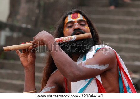 NASHIK - SEP 15:An unidentified Sadhu plays flute as he attends the Maha Kumbh Mela on September 15, 2015 in Nashik, India.Kumbhmela is a Hindu religious event gathered by millions.