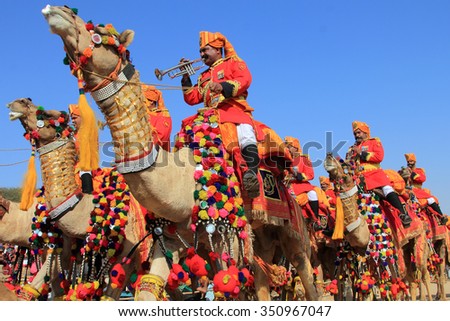 JAISALMER, INDIA - FEB 01:Traditionally dressed border security people sitting on camels attend a cultural procession for the Desert festival held on February 01, 2015 in Jaisalmer, Rajasthan, India.