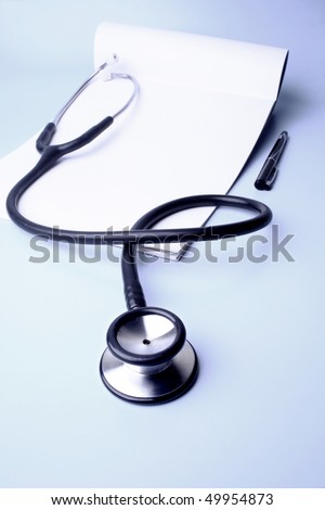 A stethoscope kept on a prescription pad