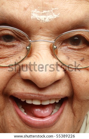 Close up face of a happy Indian senior lady