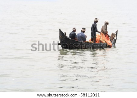 ALLEPPEY, INDIA - JULY 27 : Fishing in wooden boat at Arabian sea by local fishermen July 27, 2010 in Alleppey, India.