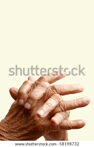 Crossed  fingers of an old asian woman