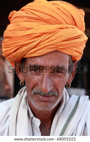 PUSHKAR, INDIA - NOVEMBER 18: A traditional Rajasthani man with turban at Pushkar Fair on November 18, 2010. Pushkar fair is held annually in Rajasthan to trade camels, horses and cattle