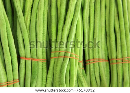 Bunches of green beans tied with red bands