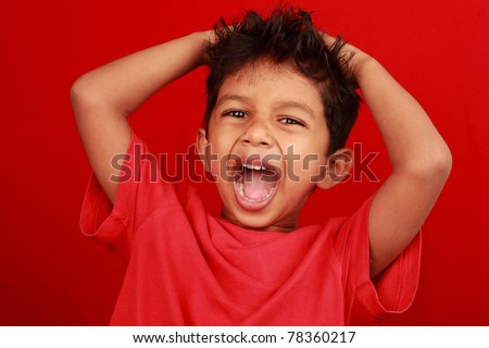 A boy screaming loud with mouth wide open