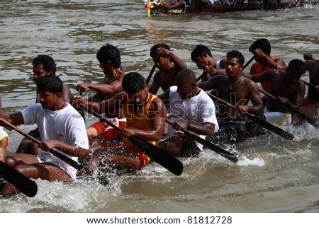 KOTTAYAM, INDIA - AUGUST 29 : Oarsmen in a snake boat team row vigorously in the Kottayam Boat race on August 29, 2010 in Kottayam, India.