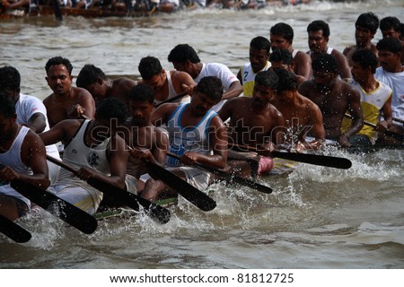 KOTTAYAM, INDIA - AUGUST 29 : Oarsmen in a snake boat team row vigorously in the Kottayam Boat race on August 29, 2010 in Kottayam, India.