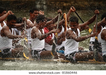 KUMARAKOM, INDIA - AUGUST 24 : Oarsmen of a snake boat team row aggressively in the Kumarakom Boat race on August 24, 2010 in Kumarakom, Kerala, India.