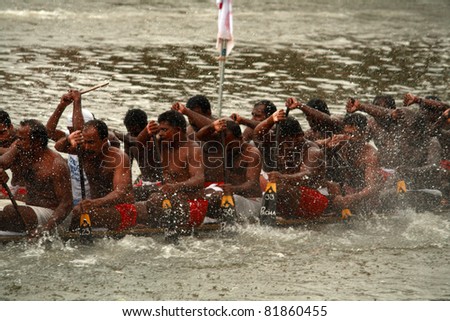 THIRUVALLA, INDIA - AUGUST 23 : Oarsmen of a snake boat team row aggressively in the Pumba Boat race on August 23, 2010 in Thiruvalla, Kerala, India.