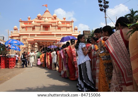 KOLKATA - OCTOBER 17: Women devotees stand in long queue to offer prayers to Goddess Durga during Durga Puja festival on October 17, 2010 in Kolkata, India.