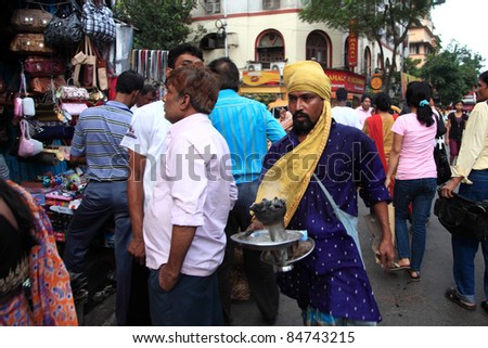 KOLKATA - OCTOBER 15: An unidentified frankincense fanner does his job in the crowded streets on 15, 2010 in Kolkata, India. Even though its a spiritual practice many people does this for a living.