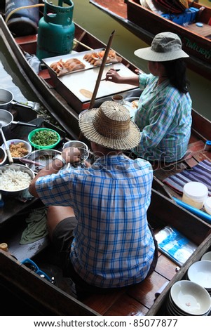 RATCHABURI, THAILAND - FEB 13:Locals prepare Thai food at Damnoen Saduak floating market on February 13, 2011 in Ratchaburi, Thailand. Its popular for old and  traditional way to sell and buy food.