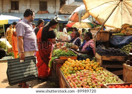 TRIVANDRUM - DEC 02: Unidentified  woman sells fruits in a crowded market on December 02, 2011 in Chalai, Trivandrum, India. Chalai is the biggest market in the capital city of Kerala state.