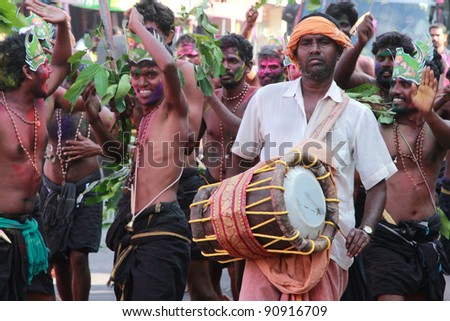 ERUMELI, INDIA - DEC 16 : Devotees of Lord Ayyappa sing and dance at a procession on their way to Sabarimala on December16, 2011 in Erumeli, India. Around 50 million visit Sabarimala every year