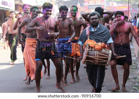 ERUMELI, INDIA - DEC 16 : Devotees of Lord Ayyappa sing and dance at a procession on their way to Sabarimala on December16, 2011 in Erumeli, India. Around 50 million visit Sabarimala every year