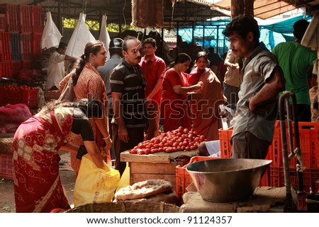 TRIVANDRUM - DEC 02: Local people buy vegetables in a crowded market on December 02, 2011 in Chalai, Trivandrum, India. Chalai is the biggest market in the capital city of Kerala state.