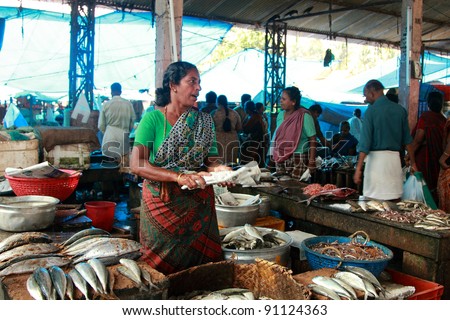 TRIVANDRUM - DEC 02: Unidentified woman sells fish in a crowded market on December 02, 2011 in Chalai,Trivandrum, India. Chalai is the biggest market in the capital city of Kerala state.