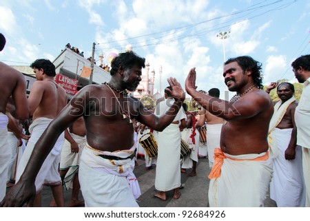 ERUMELI, INDIA - JAN 12 : Devotees sing and dance at the Petta Thullal procession on January 12, 2012 in Erumeli, India. Petta Thullal is a mass frenzied dance performed by devotees of Lord Ayyappa.