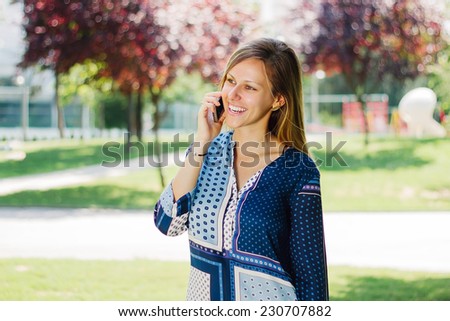 Girl smiling on the phone and looking to the side