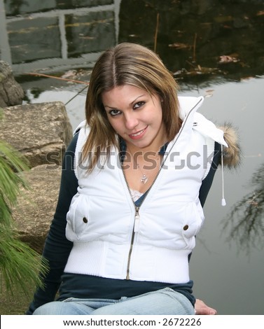 beautiful girl in zen garden sitting on rocks