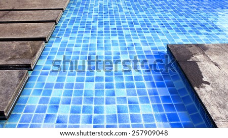 Pool with blue ceramic tiles and water ripple effect