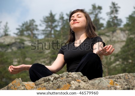 Beautiful European girl meditates on the nature.