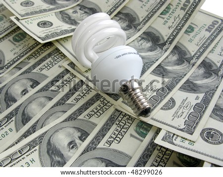 Compact fluorescent bulb against dollar background