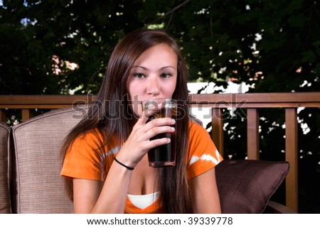 Close up on a Beautiful Girl Talking Drinking Soda Outside