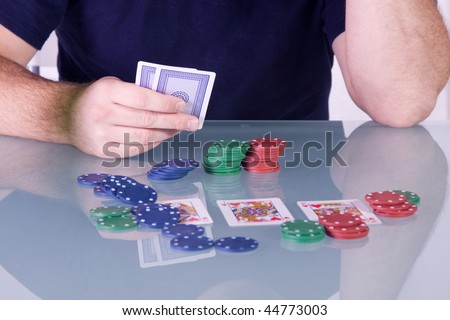 Man Holding Cards on the Table in Texas Hold\'em - Royal Flush