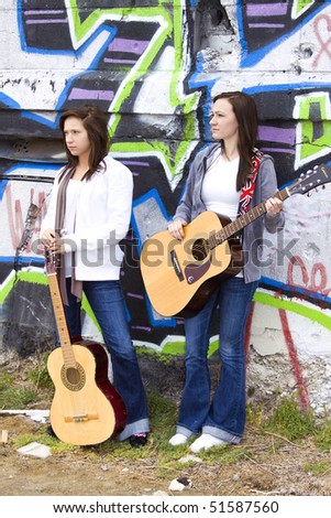 Beautiful Teenagers in a band posing by the Wall