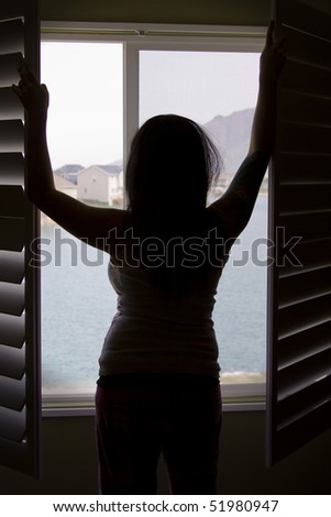 Woman by the Window Stretching in the Morning - Silhouette