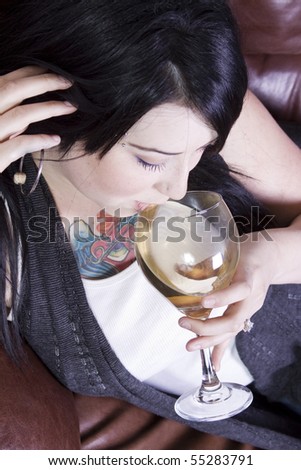 Woman Relaxing on the Couch with a Glass of Wine