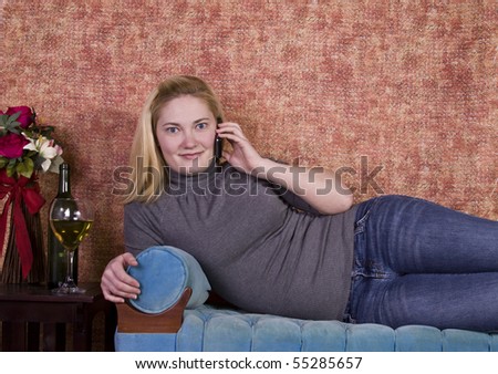 Beautiful Woman Relaxing by Laying on the Couch and Drinking Wine