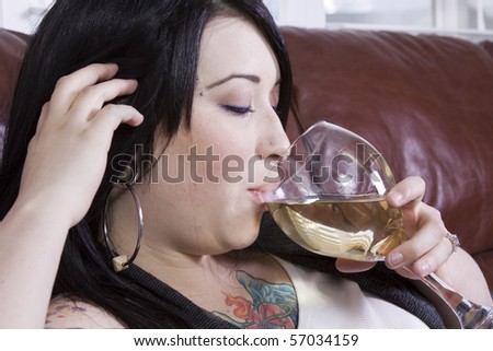 Woman Relaxing on the Couch with a Glass of Wine