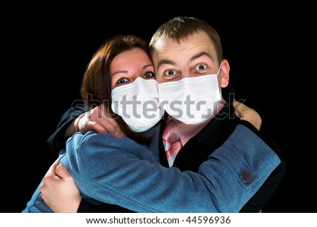 afraid man and woman dressings mask isolated on black