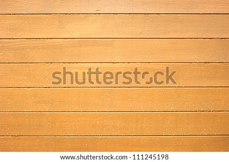 Sandy brown wood wall with water drops as background  horizontal view