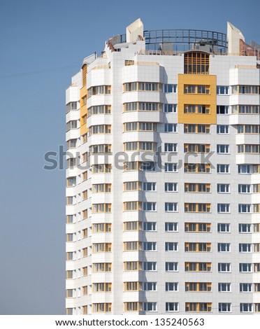 New constructed residential building over blue clear cloudless sky vertical view