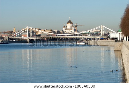 View from Moskva-river on Crimean bridge and Christ the Savior Cathedral in Moscow under clear blue sky