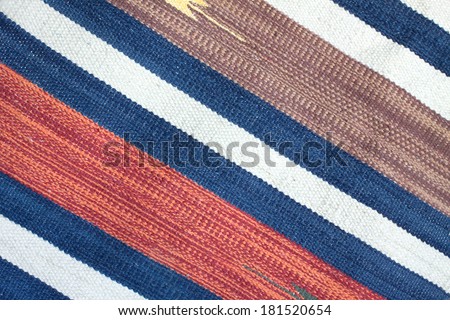 Woven fabric with color stripes as texture background diagonal view closeup