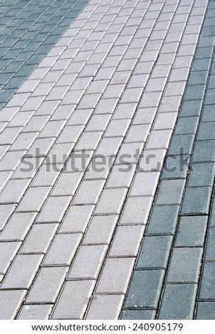 Outdoor road gray stone tiles closeup. Vertical view