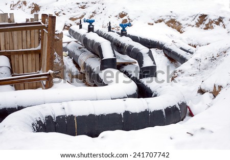 New water pipes with insulation mounting in a ground in winter day