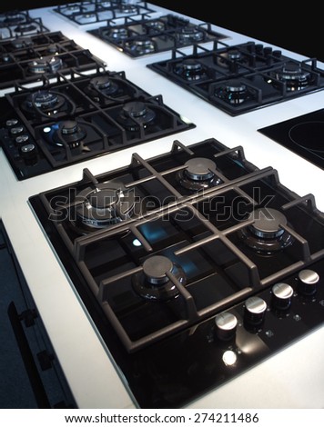 Exposition of many modern gas stoves for kitchen. Diagonal view closeup