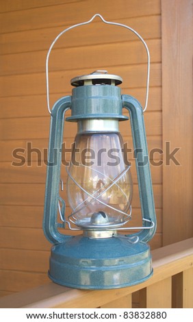 Retro oil kerosene lantern over country house part closeup