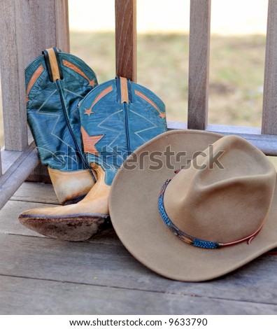 Cowboy Hat and boots leaning against railing