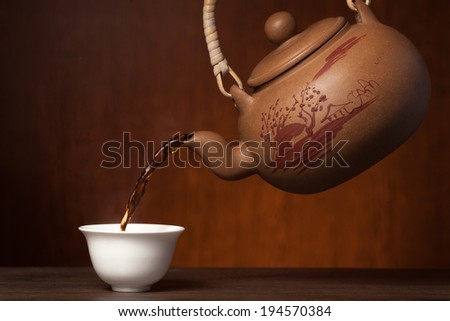 asian ceramic teapot on wooden background