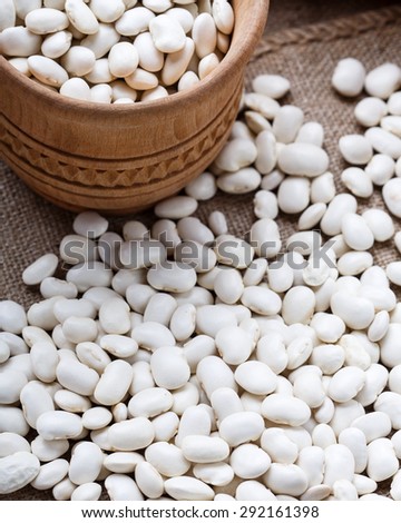 The wooden bowl full of the white lima beans