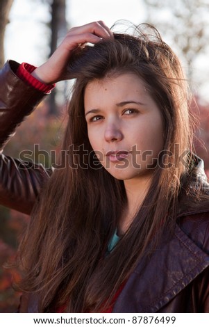 Portrait of girl with hand in hair in the park