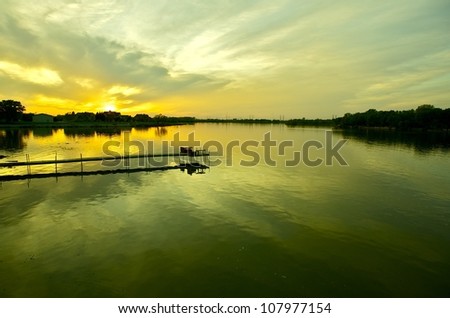 Calm Waters Sunset. Calm Waters of the Lake During Spring Sunset. Horizontal Panoramic Photography